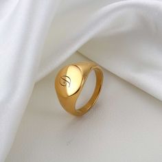 One of the most iconic ring designs, the Signet style is loved for its minimalist aesthetic and endless versatility. You can customize this Initial Signet Ring to feature the letter of your choice in an artful script font as personalized jewelry for your loved one- or a stylish piece to add to your daily rotation. Available in a timeless silver or elevated gold finish, it's the perfect piece to wear alone or layer with your other everyday styles. M A T E R I A L ■ This Alphabet Ring made of high quality 316L surgical Stainless Steel. ■ Designed to never fade, rust, tarnish, corrode, or stain. ■ Hypoallergenic, nickel-free casted material. ■ Will not turn skin green. O T H E R ∙ I N F O R M A T I O N ■ All items are nicely packaged ready to gift in elegant jewelry boxes and bag. ■ All our j Alphabet Ring, Gold Initial Ring, Gift Valentines Day, Letter Ring, Alphabet Design, Custom Ring, Initial Ring, Custom Initials, Gold Letters