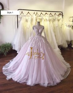 a wedding dress is displayed in front of other gowns