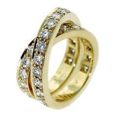 two gold rings with white diamonds on each one and an open band in the middle