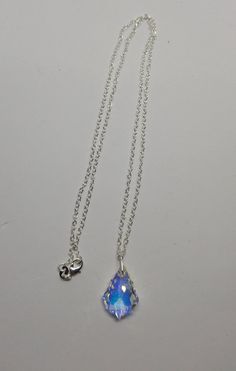 "This beautiful clear Aurora Borealis AB Swarovski crystal baroque drop hangs on a sterling silver chain. **Crystal Clear AB (Aurora Borealis) is a shimmering, iridescent rainbow effect that creates an even greater sparkling quality to the base color and reflects varying colors depending on the angle of light. Pick you chain: 16\" Cable, 18\" Cable, 20\" Cable, or 24\" Cable Pendant Size: 22x15mm Necklace is packaged in a white cotton-filled gift box. **Matching Earrings Available** https://www. Silver Sterling Silver Teardrop Pendant Crystal Necklace, Silver Drop Crystal Necklace Gift, Silver Teardrop Crystal Necklace Gift, Silver Teardrop Crystal Necklaces For Gift, Silver Teardrop Gemstone Crystal Necklace, Silver Drop Crystal Necklace For Gift, Teardrop Crystal Necklace Gift, Teardrop Crystal Necklace For Gift, Gift Teardrop Crystal Necklace