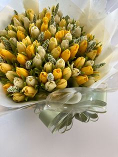 a bouquet of yellow and white tulips