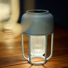 a white light sitting on top of a wooden table