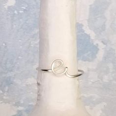 This dainty, personalized E initial ring is adjustable and the perfect way to show some self love, wear as friendship rings with your best buds, give to your bridesmaids as a thoughtful gift they will treasure forever, or to your girlfriend to keep you in her thoughts! Wrapped by hand using nickel free, non tarnish, high quality wire, this letter ring is custom made JUST FOR YOU!-----------------------------------------------MATERIAL: The wire is made out of high quality non-tarnish coated coppe Adjustable Initials Stackable Rings For Everyday, Everyday Adjustable Stackable Rings With Initials, Adjustable Hypoallergenic Initial Ring For Everyday, Dainty Adjustable Stackable Initials Rings, Dainty Adjustable Stackable Rings With Initials, Personalized Initial Open Ring, Personalized Adjustable Initial Open Ring, Adjustable Dainty Initial Ring For Promise, Minimalist Adjustable Initial Ring, Hypoallergenic