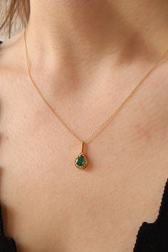 Nestled within the luminous embrace of 18K gold lies a tale of timeless allure and ethereal beauty. Behold the elegant majesty of our Emerald Drop Necklace, a celestial cascade of emerald and diamond, where each glimmering facet whispers secrets of enchantment and grace. In the heart of this exquisite pendant, an emerald teardrop, radiant with nature's most verdant hues, casts its spell, invoking visions of lush forests and dew-kissed mornings. With each gentle sway, it dances, a silent tribute to the wonders of the earth and the mysteries of the universe. Surrounding this emerald gemstone, a constellation of diamonds shines forth, a celestial halo that captures the essence of stardust and dreams. Each diamond, a twinkling star in the vast expanse of night, whispers promises of love and et Elegant Emerald Necklace With Prong Setting As Gift, Elegant Teardrop Pendant Birthstone Necklace, Elegant Oval Pendant Birthstone Necklace, Elegant Teardrop Gemstone Birthstone Necklace, Elegant Teardrop Emerald Birthstone Necklace, Elegant Wedding Birthstone Necklace With Gemstones, Elegant Oval Birthstone Necklace, Elegant Wedding Birthstone Necklace, Elegant Teardrop Emerald Necklace As A Gift