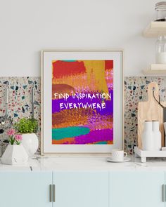 a framed art print with the words find inspiration everywhere in purple, orange and pink