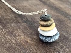 Feel the sea and the sand with this natural beach stone necklace. Have the beauty of the ocean with you! This necklace is created with a variety of hand picked stones from the beach. Each necklace is unique, like the beautiful stones that it is created with. The beach pebbles have the colours of earth, white, black, gray, brown, beige compined with sterling silver 925. The pendants measure approximately 2.5cm - 1 inch. ▶ You can choose the length of your chain from 15 inches to 34 inches. The le Balance Stones, Pebble Necklace, Beach Pebbles, Beach Rocks