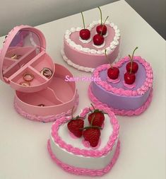 three heart shaped cakes with two cherries in the middle and one strawberry on top