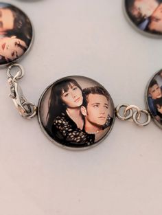 In memory of the late great Shannen Doherty and Luke Perry I was requested to make this bracelet, this is a memorial piece featuring mainly Brenda Walsh, and Dylan McKay. The bracelets are 7 in in length and can be ordered smaller but one charm would need to be removed. but they also can be ordered with extenders up to 2 in. This memorial piece is a tribute to Shannen Doherty and her iconic work in shows such as Beverly Hills 90210, Chamed, and Little House on the Prairie. May she and Luke rest Retro Jubilee Bracelet Jewelry As Gift, Retro Bracelet Jewelry As Gift, Handmade Retro Bracelets As Gift, Customizable Adjustable Vintage Jewelry, Adjustable Customizable Vintage Jewelry, Vintage Friendship Bracelet Jewelry, Customizable Themed Jewelry Bracelet, Retro Bracelet As Gift, Retro Round Bracelet Gift