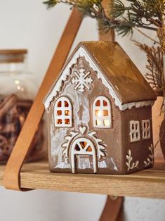 a gingerbread house is sitting on a shelf