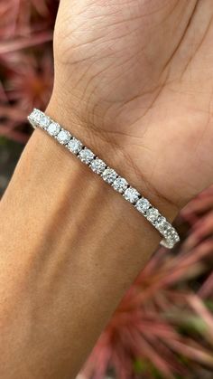 This is one of our most beloved and beautifully handcrafted lab diamond bracelet. This bracelet is studded with 9.42 carat Lab Diamonds that are round-cut. The bracelet is set in 10.95 grams 18K White Gold. The lab-grown diamonds used in this bracelet are created using advanced Chemical Vapor Deposition (CVD) technology, a process we proudly specialize in. These diamonds possess the same physical, chemical, and optical properties as diamonds, ensuring they sparkle with unparalleled brilliance and radiance. Each CVD diamond reflects light beautifully, creating a dazzling display that is indistinguishable from that of natural diamonds. This bracelet is a celebration of both beauty and ethical craftsmanship. Lab-grown diamonds offer a sustainable and environmentally friendly alternative to tr Luxury White Diamond Bracelet With Brilliant Cut, Luxury Round Cut Tennis Bracelet For Formal Occasions, Luxury Tennis Bracelet With Round Cut For Formal Occasions, Luxury Lab Grown Diamond Bracelet, Exquisite Platinum Tennis Bracelet With Diamond Accents, Luxury Platinum Tennis Bracelet With Single Cut Diamonds, Luxury Diamond White Diamond Bracelet For Anniversary, Luxury Diamond White Lab Grown Diamond Bracelets, Luxury Diamond White Lab Grown Diamond Bracelet