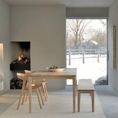 a dining room with a table and chairs in front of a fire place