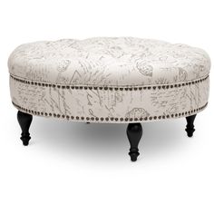 a white ottoman sitting on top of a wooden table