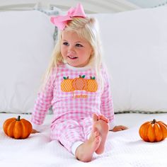 The sweetest pink gingham knit loungewear! Features triple pumpkin applique with white rib trim. Perfect for the season!