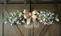 a wooden door with two wreaths on it and the words victoria's treasures