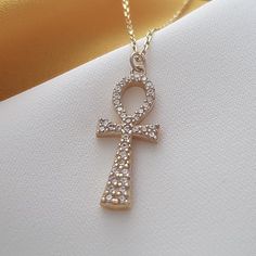 14k Solid Gold Ankh Necklace, Cross Necklace, Guardian Angel, Religious Necklace, Ankh Charm Necklace, Christian Cross,Gift Necklace For Her The necklace is made with 14k solid gold.. All the pieces in the necklace are solid gold..                                                              We use lobster clasp on the chain..         The chain thickness is 0.85mm.    Gemstone: Cubik Zirconia Pendant height: 21 mm  Pendant width : 9 mm The chain is produced adjustable..  For example: 22 inches adjustable 21 inches, 20 inches adjustable 19 inches, 18 inches adjustable 17 inches, 16 inches adjustable 15 inches Handmade Gold Ankh Necklace, Handmade Ankh Gold Necklace, Gold Necklaces With Gemstone Cross Pendant, Gold Necklace With Gemstone Cross Pendant, Gold Cross Amulet Necklace, Gold Ankh Necklace Gift, Gold Symbolic Gemstone Necklace, Symbolic Gold Necklace With Gemstone, Gold Ankh Necklace For Gift