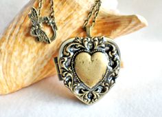 Music box locket, heart locket with music box inside, in bronze with lacey edge floral heart on cover. Elegant Handmade Antique Gold Locket Necklace, Vintage Heart-shaped Necklace For Gift, Vintage Heart Shaped Necklace For Gift, Vintage Heart Necklace For Gift, Vintage Pendant Locket Necklace For Valentine's Day, Vintage Heart Locket Pendant Necklace, Antique Gold Locket Necklace Gift, Vintage Heart Charm Locket Necklace As A Gift, Vintage Heart Keepsake Necklace