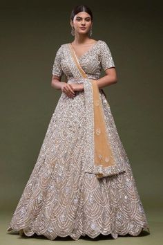 Made to Order/Measurement/Custom Order Lehenga - Color : off white - Fabric : Sequin Georgette - Fully flared paneled lehenga - Embroidered  Blouse -  Net Dupatta with Gold Border - Drawstring closure with Tassels - - It can be customize in any design or size  PLEASE NOTE: BUYERS ARE RESPONSIBLE FOR ANY CUSTOMS AND IMPORT TAXES THAT MAY APPLY. This is a made to order product. If you opt for 'Made To Measurement Option', we will provide a measurement template and you can share the measurements li Beige Anarkali Set With Zari Work For Reception, Off White Floor-length Gown With Dupatta, Beige Anarkali Set With Traditional Drape For Reception, Traditional Drape Off White Lehenga For Reception, Fitted Cream Sharara With Traditional Drape, Traditional Cream Floor-length Gown, Cream Semi-stitched Lehenga For Reception, Semi-stitched Cream Gown For Diwali, Cream Semi-stitched Gown For Diwali