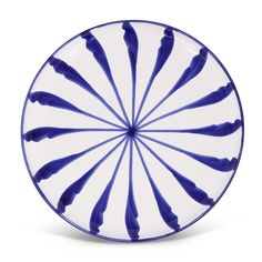 a blue and white plate on a white background with an abstract design in the center