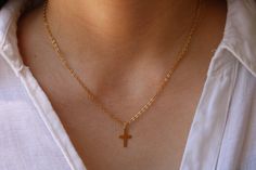 This simple cross necklace is perfect for the minimalist. D E T A I L S *It features a small gold filled cross measuring 15mm and with a thickness of 0.45mm (25gauge). *It is suspended from a sparkly 18k gold filled chain. *Gold fill is an actual layer of pure gold that is pressure bonded to a base metal and unlike gold plated items does not tarnish or rub off. *It closes with a  gold filled hallmarked spring ring clasp. C A R E * T I P To keep your necklace in good condition please avoid contac Simple Cross Necklace, Cross Necklace Simple, Simple Cross, Gold Cross Necklace, Necklace Simple, Christening Gifts, Chain Gold, Gold Cross, Pure Gold