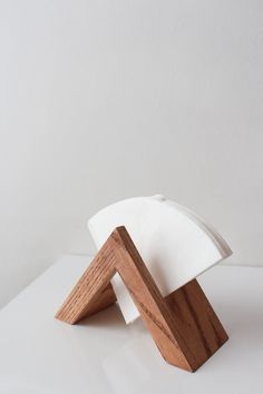 a wooden object sitting on top of a white surface