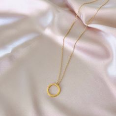 Our signature gold circle necklace is designed for layering over any necklace in our collection. Handmade, tarnish resistant 14k gold plated chain. Adjustable between 16"-18". Dainty Gold Chain Round Necklaces, Dainty Round Gold Chain Necklace, Gold Circular Charm Necklace With Adjustable Chain, Dainty Gold Chain Round Charm Necklace, Gold Minimalist Open Circle Necklace, Minimalist Gold Open Circle Necklace, Everyday Circular Cable Chain Necklace, Gold Necklaces With Delicate Open Circle Chain, Gold Plated Circle Necklace With Adjustable Chain