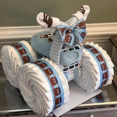 a cake made to look like a car with wheels and teddy bears on the tires