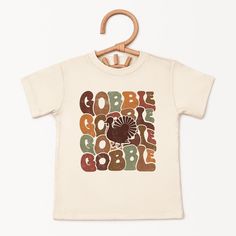 Looking for a cute tee for your kids? We have the perfect Gobble Turkey graphic tee addition to their closet! Also available in toddler tees. Playful Cartoon Print T-shirt For Fall, Playful Fall T-shirt With Cartoon Print, Playful Pre-shrunk T-shirt For Fall, Playful Crew Neck T-shirt For Fall, Unisex Letter Print T-shirt For Fall, Playful Short Sleeve T-shirt For Fall, Playful Short Sleeve Fall T-shirt, Unisex Fall Short Sleeve T-shirt, Unisex Short Sleeve T-shirt For Fall