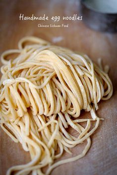 a pile of noodles sitting on top of a wooden cutting board