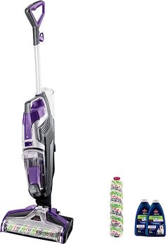 a purple and white vacuum is next to several cleaning products on a white background,