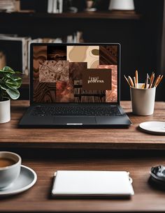 an open laptop computer sitting on top of a wooden desk next to a cup of coffee