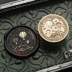 two coins sitting on top of a metal tray