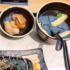 three bowls filled with food on top of a table