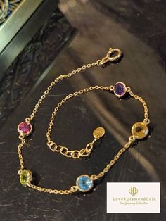 Gift yourself or your loveonce this beautiful Dainty Gem Bracelet. Set in 18 Karat of Gold. * Materials: 18Karat Gold, Citrine, Amethyst, Blue Topaz, Pink Sapphire, Peridot * Gold Color: Yellow Gold * Chain Length: 6.5 Inches-7.5 Inches (Adjustable) * Chain Width: .9mm *Gem Width: 4.6mm * 5 Gemstones * Weight: 1.32grams 💎 NOT Gold Plated; Not Gold Filled. *Some photos might be enlarged to get an accurate description and image. Pls see the item's description before checking out. 💥PLS FOLLOW US Luxury Multi-stone Bracelets As Gift, Yellow Gold Cubic Zirconia Crystal Bracelet Gift, Fine Jewelry Multi-stone Bracelet As Gift, Multi-stone Round Gold Bracelet As Gift, Gold Multi-stone Bracelet As Gift, Fine Jewelry Multi-stone Bracelets For Gifts, Round Multi-stone Gold Bracelet As Gift, Luxury Gold Bracelets With Gemstone Accents, Cubic Zirconia Bracelets With Gemstone Accents Gift