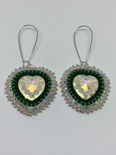 Handmade beaded earrings with heart shaped centres. Made with seed beads in forest green, and rhinestone banding. Backed with white material and using kidney ear wire hooks. Each earring measures approximately 1.5 inches wide and 3 inches long completed (including the hook). Jewelry Making Business, Handmade Beaded Earrings, Ribbon Skirts, Handmade Earrings Beaded, Ribbon Design, White Material, Ear Wire, Forest Green, Beaded Earrings