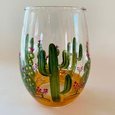 there is a glass that has some plants on it in the shape of a cactus