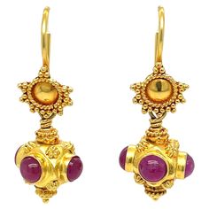 Bright and colorful, this modest size earring pair displays four cheerful 3.5mm pink ruby cabochons on each that are bezel set in a fancy ornamental 18 karat yellow gold setting. Anchoring the drop is an decorative gold disc that host the easy to apply fish hook closure. The length of the earring from top to bottom is 1-1/4 inches, allowing the pair to provide just enough provide a bit of movement without being too dramatic. Great gift or treat yourself and add a splash of color to any look. Gif Earring Video, Yellow Gold Drop Earrings, Pearl Drop Earrings Gold, Pink Ruby, Gold Disc, Yellow Gold Setting, White Gold Earrings, Diamond Drop Earrings, Modern Earrings