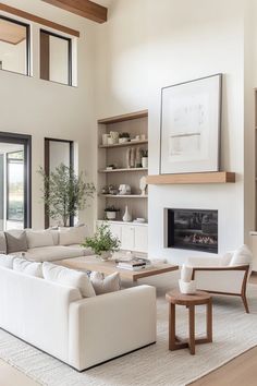 a living room filled with furniture and a fire place in the middle of a room