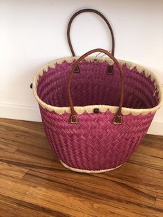 These beautiful pieces are designed in South Africa. Handmade with raffia and featuring leather handles, these bags bring the perfect mix of bohemian chic to everyday wear! Capable of being used as a handbag, basket or storage-this multi-purpose piece is a cannot miss! The double closure top provides a multi-style capability as well! Sizing: 16 inches wide x 12 inches deep x 13 inches high Bohemian Bucket Bag With Leather Handles For Vacation, Bohemian Woven Bucket Bag For Shopping, Bohemian Crochet Bucket Bag With Leather Handles, Pink Bohemian Straw Tote Bag, Pink Bucket Straw Bag With Braided Handles, Shopping Bucket Beach Bag With Handles, Bohemian Straw Bag With Bamboo Handle For Shopping, Bohemian Bucket Beach Bag With Leather Handles, Bohemian Bucket Bag With Leather Handles For Shopping