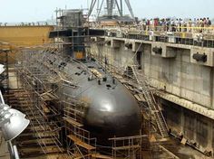 a large submarine sitting on top of a dry dock