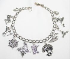 "This adorable charm bracelet is handcrafted using Rhodium Finished Nickel Free Cable Chain, 11 nickle free zinc alloy charms, Corn Charm, Moose Charm, Ics Skate Charm, Snowflake Charm, Butterfly Charm, Mushroom Charm, Minnesota State Charm, Duck Charm, Hockey Sticks Charm, Frog Charm, Apple Charm, Lobster Clasp This bracelet measures approx 7 - 1/2 \" in length. You have the option to choose other bracelets sizes and also to add an initial charm When purchasing a bracelet for someone other than Novelty Silver Hypoallergenic Bracelets, Novelty Silver Charm Bracelet Gift, Silver Novelty Charm Bracelet As A Gift, Silver Novelty Charm Bracelet Gift, Handmade Novelty Silver Bracelets, Novelty Metal Charm Bracelet As Gift, Novelty Metal Charm Bracelet Gift, Novelty Silver Hypoallergenic Charm Bracelet, Silver Metal Novelty Bracelets