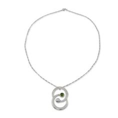 Working in sterling silver Mariana Llanes pays tribute to the zodiac sign of Gemini. The finely handcrafted necklace features peridot's green tonalities. .925 Sterling silver Anniversary Green Engraved Necklace, Modern Green Necklace With Polished Finish, Round Peridot Birthstone Necklace, Sterling Silver Birthstone Necklace With Oval Pendant, Modern Peridot Jewelry As A Gift, Modern Peridot Jewelry For Gift, Fine Jewelry Silver Necklace For May Birthstone, Fine Jewelry Peridot Necklace For Anniversary, Silver Fine Jewelry Necklace For May Birthstone