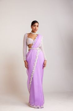 Lilac pearl embellished saree paired with pearl drop full sleeves blouse.From Vvani Vats Jhoomar collection.DELIVERY TIMEPlease allow 8-12 weeks for your outfit to arrive.FABRIC DETAILSBlouse - Georgette, Saree - OrganzaProfessional cleaning only. DISCLAIMERBelts are additional chargeable. Hanging tassel at back is additional chargeable. Saree With Full Sleeve Blouse, Light Purple Saree, Lilac Saree, Full Sleeves Blouse, Full Sleeves Blouse Designs, White Satin Blouse, Embellished Saree, Sari Design, Full Sleeve Blouse