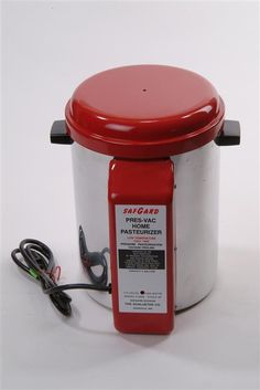 a red and white container sitting on top of a table next to a power cord