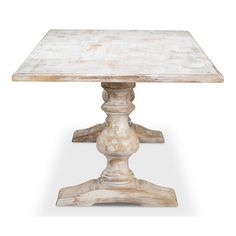 an old wooden table with white paint on the top and pedestals at the base