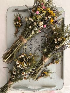 dried flowers are laid out on a tray