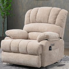 a beige recliner sitting on top of a rug