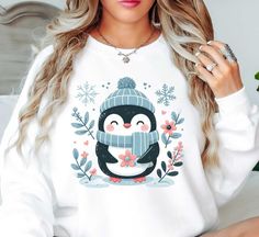 Adorable Winter Penguin Sweatshirt | Winter Fashion | Unique Gifts for Family Friends   Embrace the season in warmth and style with our cozy winter-ready crewneck winter apparel sweatshirts. Each sweatshirt is designed to lock in warmth without compromising on comfort. The soft, plush interiors provide a haven from the biting cold, while the stylish exteriors make a statement effortlessly. From snowflakes to winter-inspired designs, our collection embodies the essence of winter. Don't just survive this winter, thrive in it, adorned in comfort and fashion.   Key Features: High-Quality Material: Made from soft and durable fabric, this sweatshirt is built to last and keep you warm throughout the season. Unisex Design: This versatile pullover suits all genders, offering a relaxed and comfortab Penguin Sweatshirt, Winter Penguin, Diy Ugly Christmas Sweater, Wool Applique Patterns, Winter Apparel, Winter Inspired, Fashion Unique, Winter Sweatshirt, Cute Sweatshirts