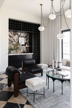 an elegant living room with black and white decor