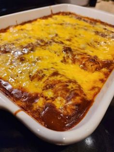 a casserole dish with cheese and meat in it