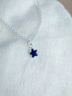 "Dainty and simple blue sapphire star necklace. Please choose your favorite necklace length at checkout. All lengths have a one inch extender, that way you'll have some wiggle room to play with the length. For example, if you choose a 14 inches necklace length, you'll have options to close the necklace at any length between 14 inches and 15 inches. Some of this charms are sold by themselves (no chain). If that option is available for this, you will have the option to buy \"CHARM ONLY\" before ad Star Locket Necklace, Blue Star Necklace, Dainty Jewelry Aesthetic, Silver Necklace Stack, Blue Jewerly, Silver Sapphire Necklace, Simple Silver Necklace, Star Locket, Star Necklaces